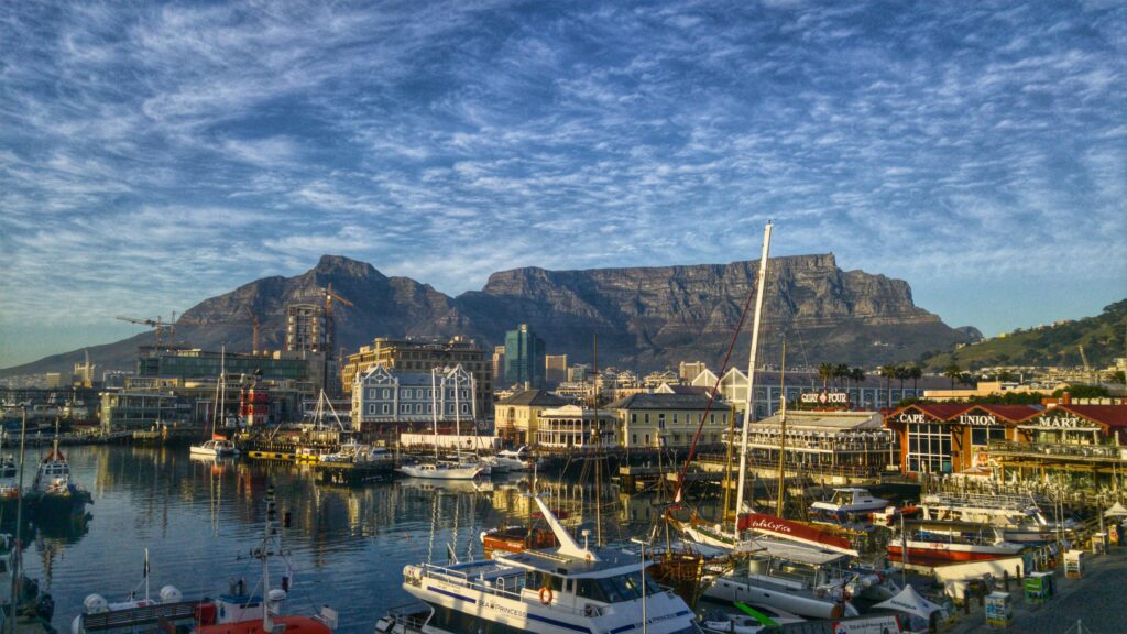 pexels-photo-259447-259447 Stunning view of Cape Town harbor with boats and iconic Table Mountain backdrop.